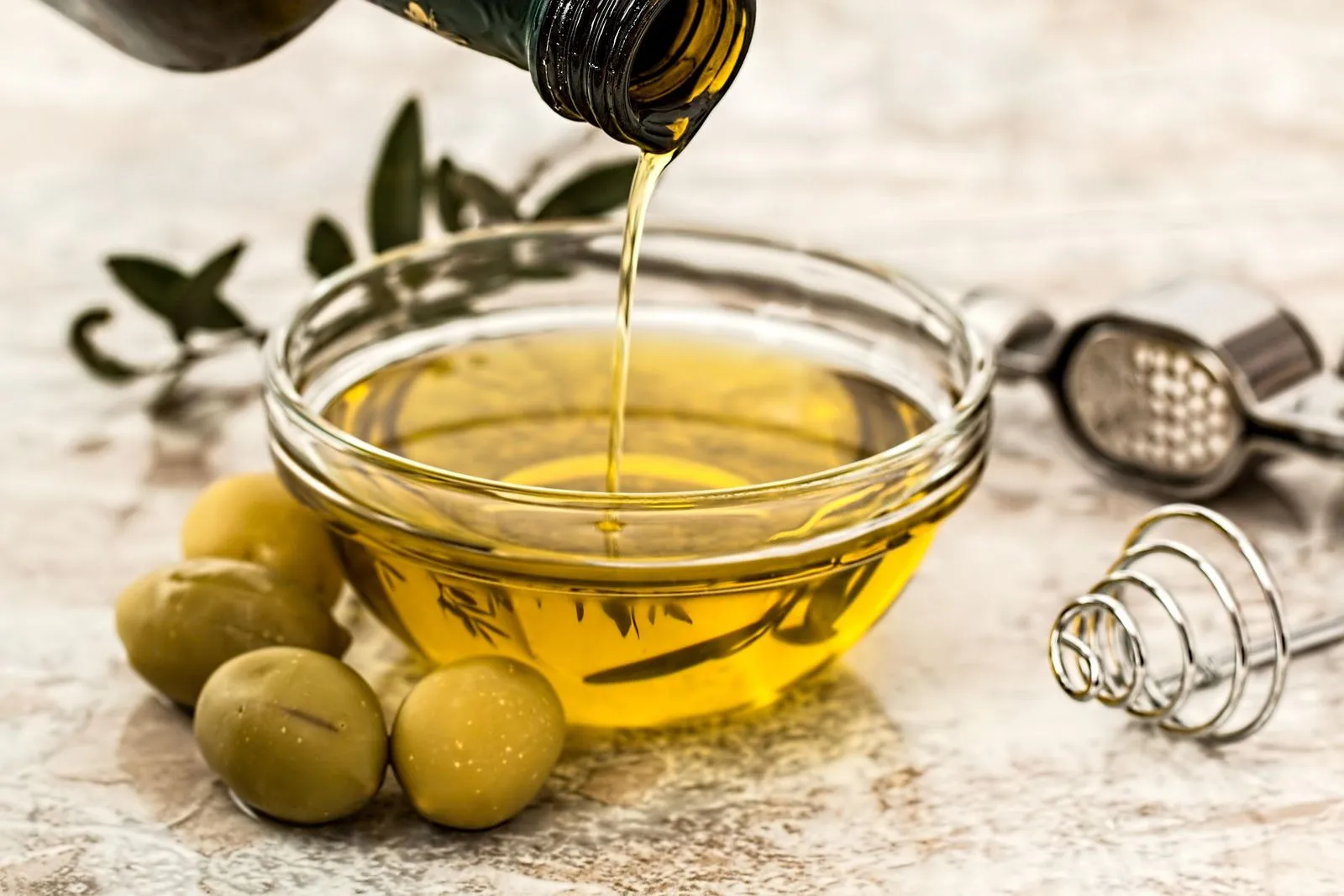 Extra virgin olive oil in a bottle – a core ingredient of the Mediterranean diet and a source of heart-healthy fats.